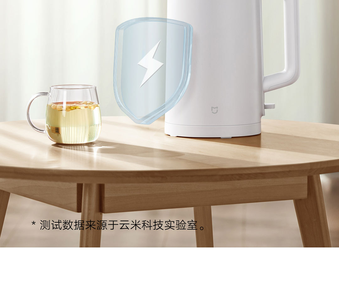 Close-up of the kettle base showing retractable power cord and visible heating indicator light